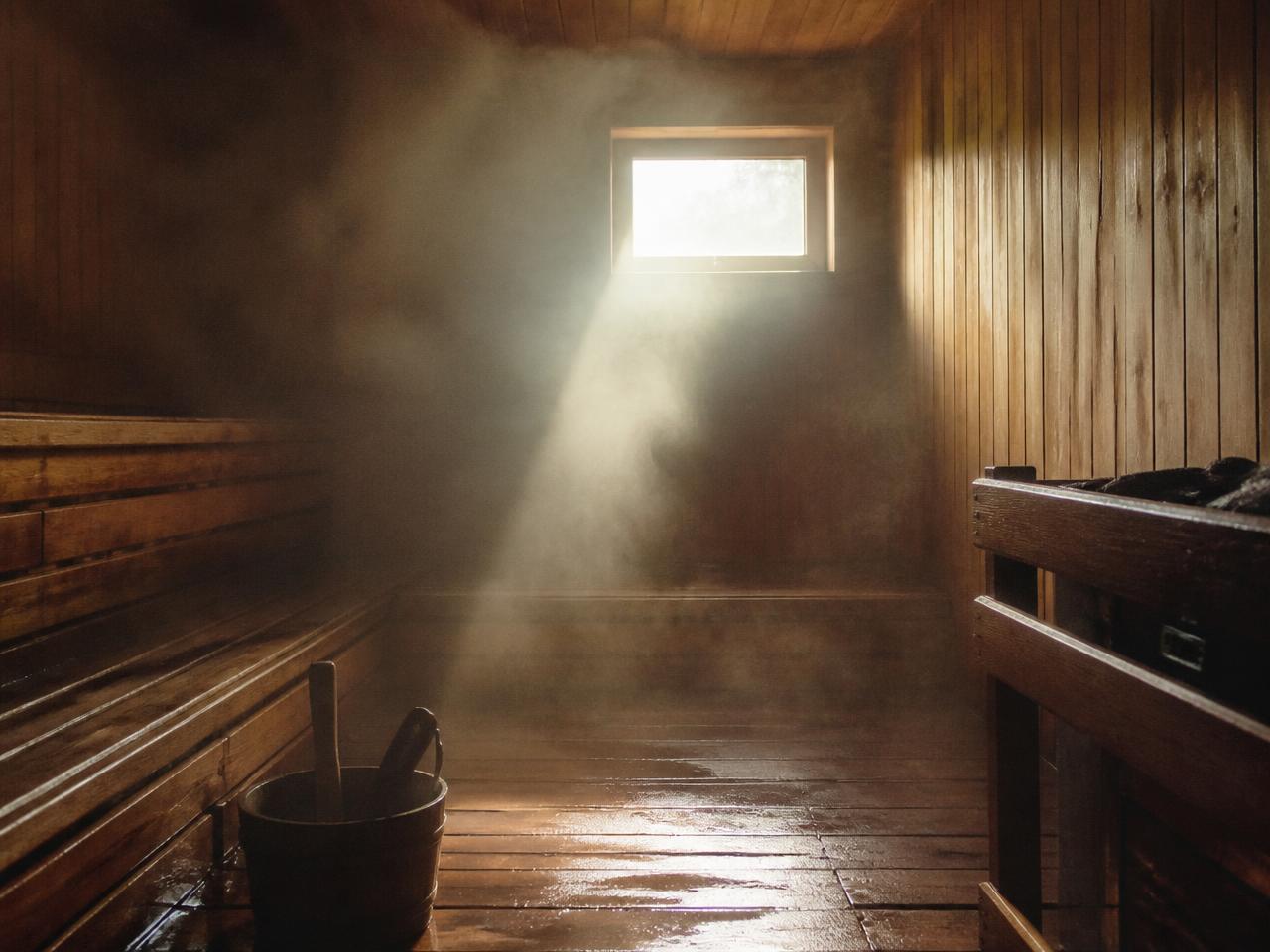 Steam and light inside a wooden sauna